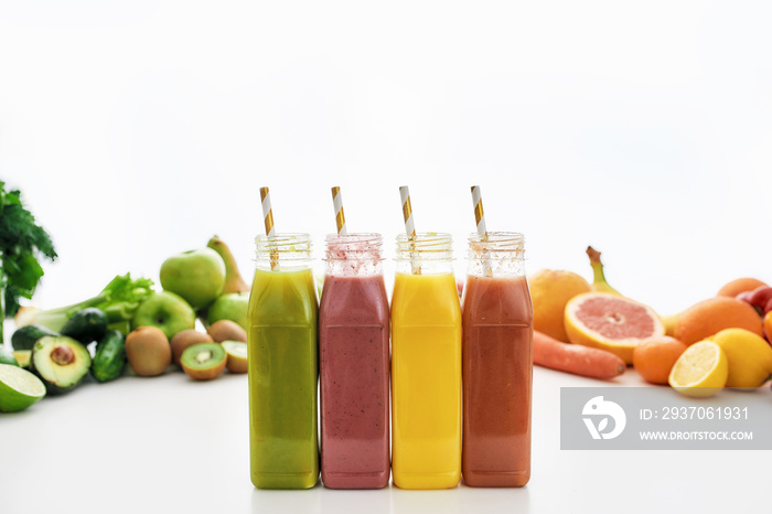 Composition of healthy detox juices and smoothies in bottles with paper straws, Various colorful fru