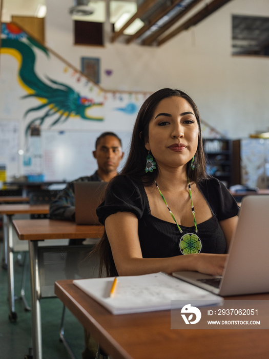 Native student looking directly at the camera and smiling in class