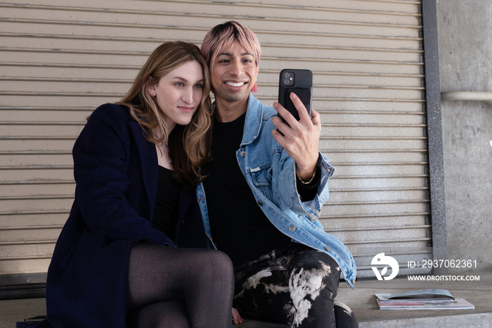 Lgbtqia friends sitting and posing together.