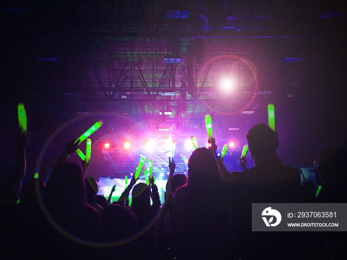 Crowd at concert : Silhouette people crowd happy and cheering with led foam stick light in front of 