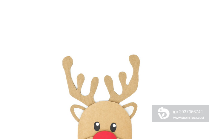 Cute and happy baby reindeer cardboard cutout with red nose peeking on a white background. Christmas