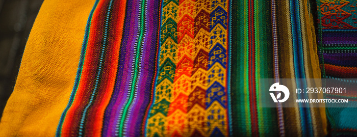 Peruvian traditional colourful native handicraft textile fabric at market in Machu Picchu, one of th