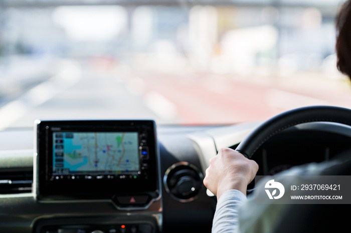 japanese middle aged woman using car navigation system