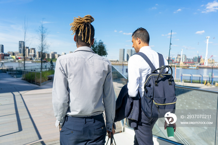 Two businessmen walking in business district