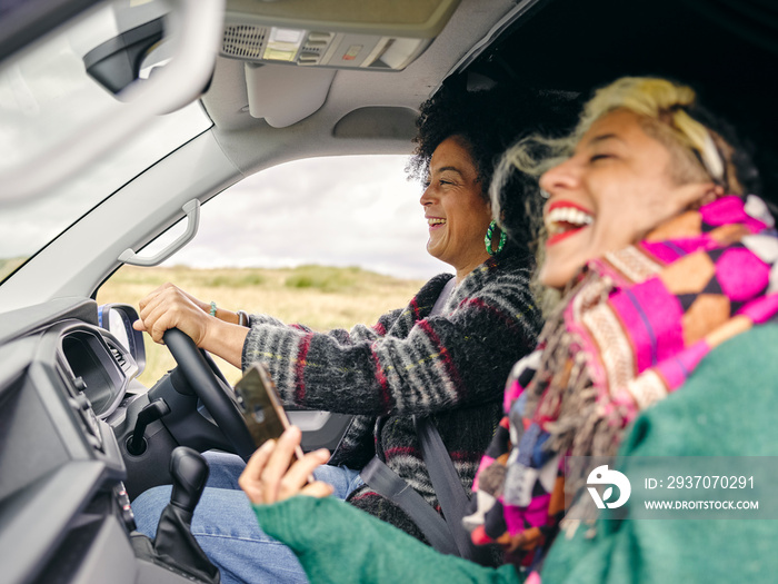 Smiling women traveling by car