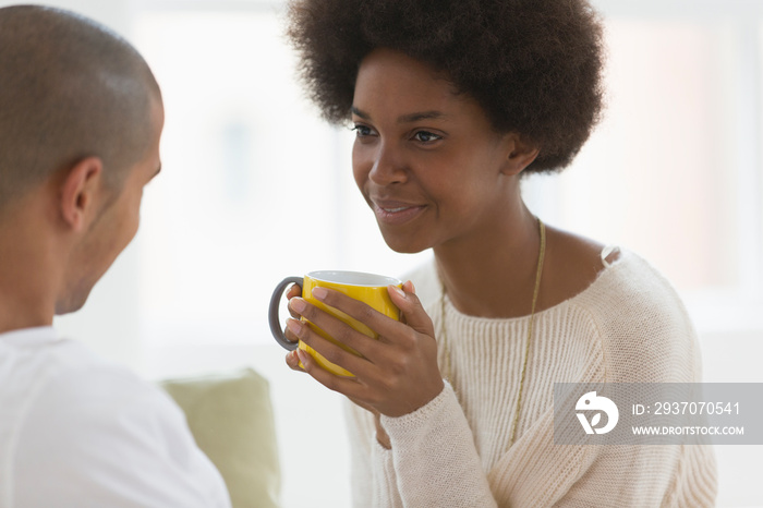 Young couple talking and drinking tea