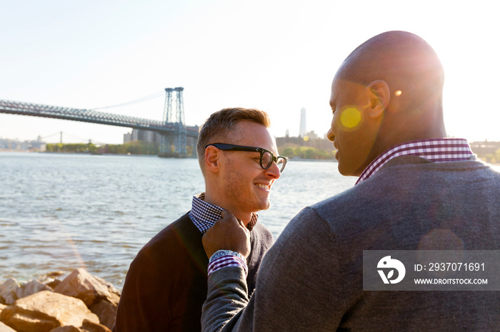 Two happy men standing on promenade with Brooklyn Bridge in background