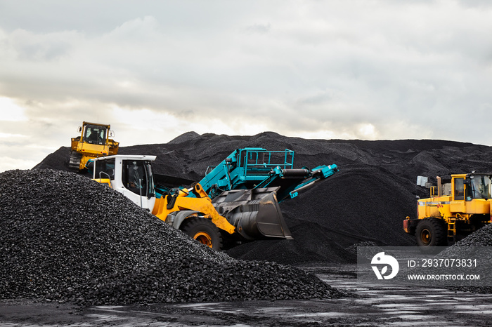 Caterpillar tractors collect black coal pile. Illustration of supply field of power station.