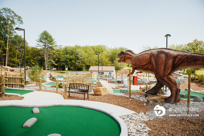 Dinosaur sculpture in Raptor Falls mini golf course