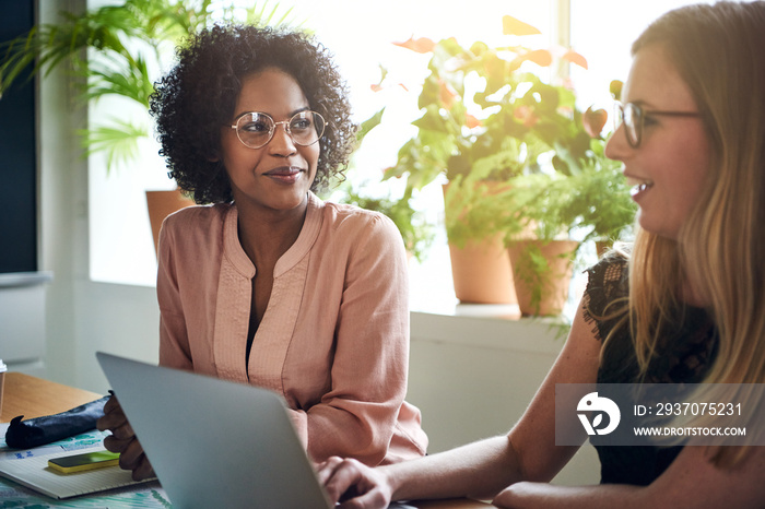 Businesswomen working together at a boardroom table in an office