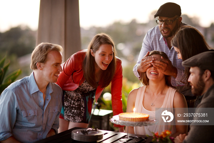 Friends celebrating birthday on patio