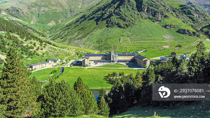 Summer view of Vall de Nuria in the catalonia pyrenees with housing next to the lake for outdoor act