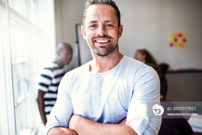 Smiling designer standing in an office after a meeting