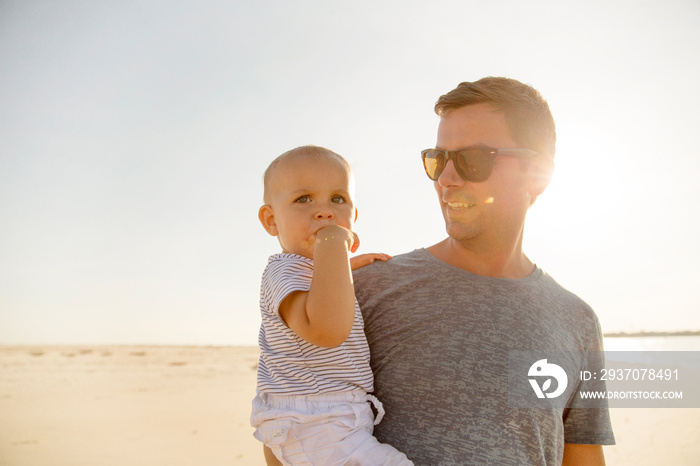 Father and baby boy (0-1 month) on beach