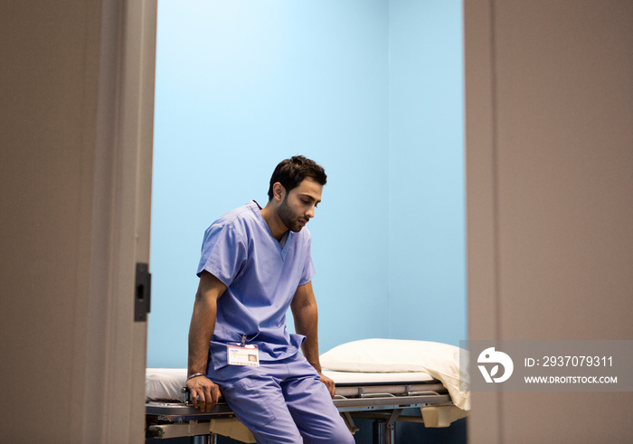 Doctor leaning at hospital bed and resting