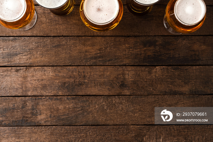 Beer glasses on wooden table with copyspace.