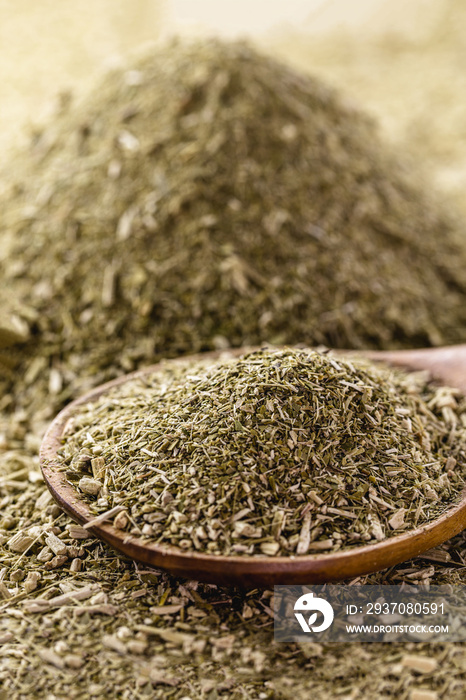 heap of yerba mate, with wooden spoon. Typical hot drink herb