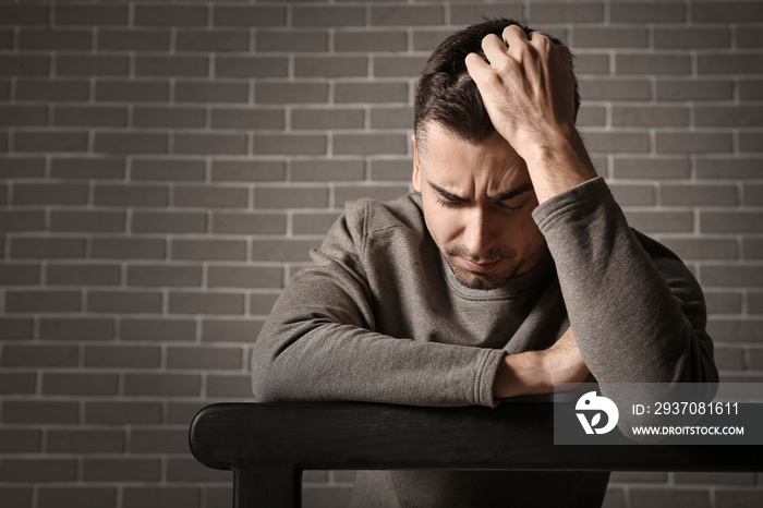 Portrait of depressed young man indoors