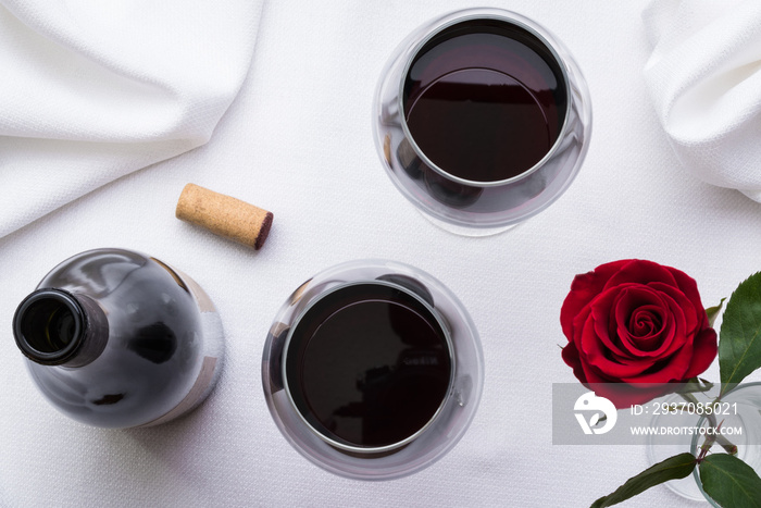 Red Wine with Bottle, Cork, and Rose on White Linen