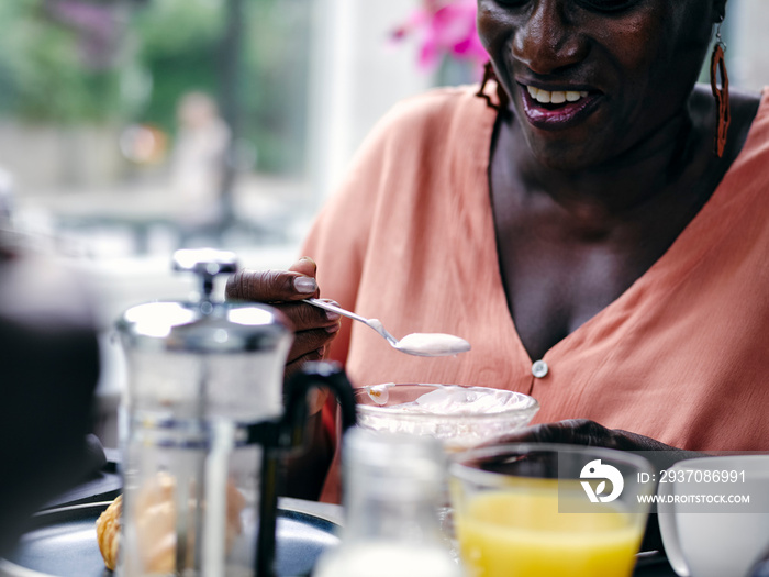 UK, Close-up of woman enjoying hotel breakfast