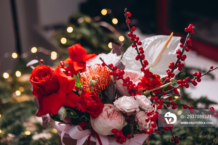 floral arrangement with red and white peony roses, exotic flowers on a Christmas background. flowers