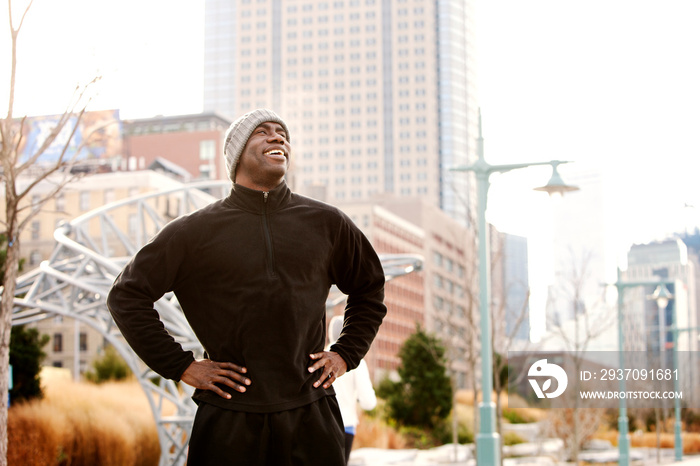 Man taking break from running in city