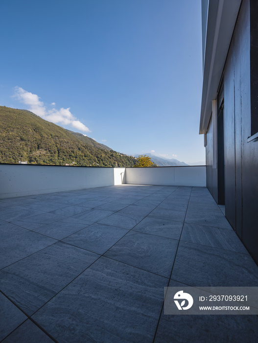 Large terrace with large marble tiles overlooking the Swiss hills in Ticino