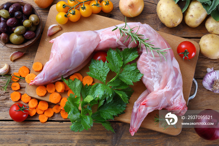 coniglio crudo intero e porzionato su tavolo di cucina