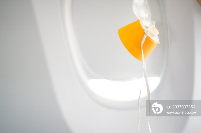 oxygen mask drop from the ceiling compartment on airplane