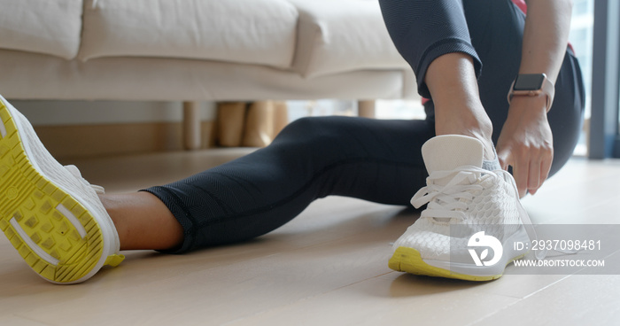 Woman wearing sport shoes at home