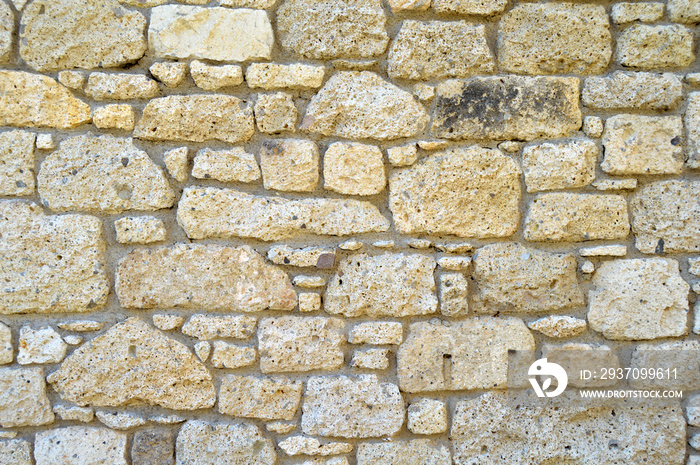 Sturdy yellow and beige cut stone wall, seamless lined up