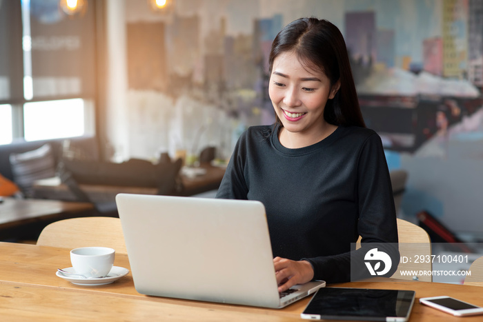 Businesswoman working online at the home office by laptop. Asian young entrepreneurs watching webina