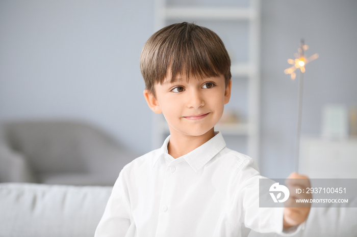 Little boy with sparkler at home