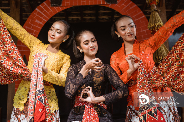 portrait of a young woman wearing Javanese kebaya traditional clothes with dancing pose