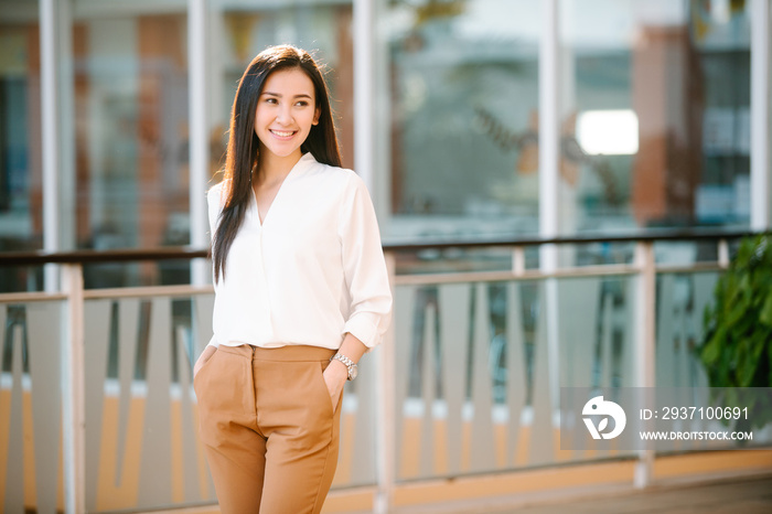 portrait of beautiful woman business executive style in downtown urban area