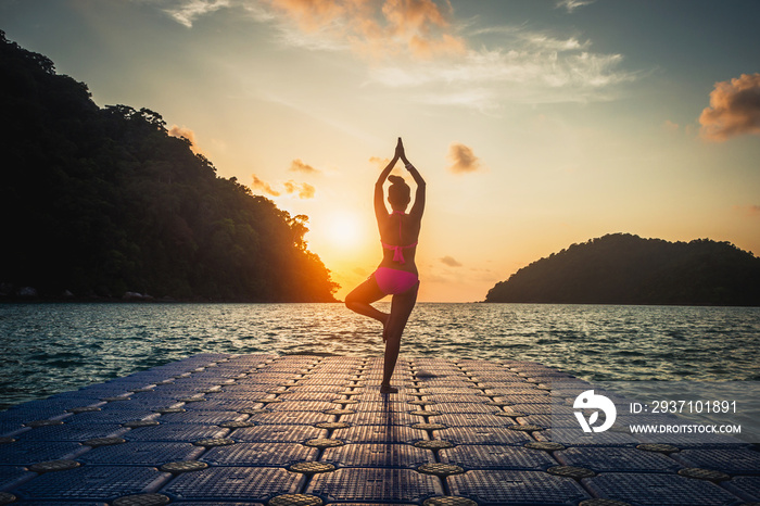 Silhouette wellness woman in bikini practice yoga on sea beach at sunset time Surin island, Active h