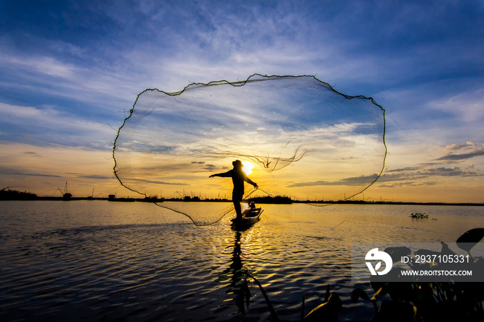 fishermen throwing net fishing in lake on morning sunrise