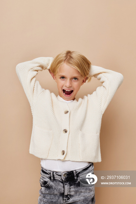 Little cute girl gestures with his hands posing studio