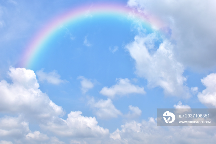 Abstract rainbow on beautiful blue sky and white clouds as background and wallpaper. 