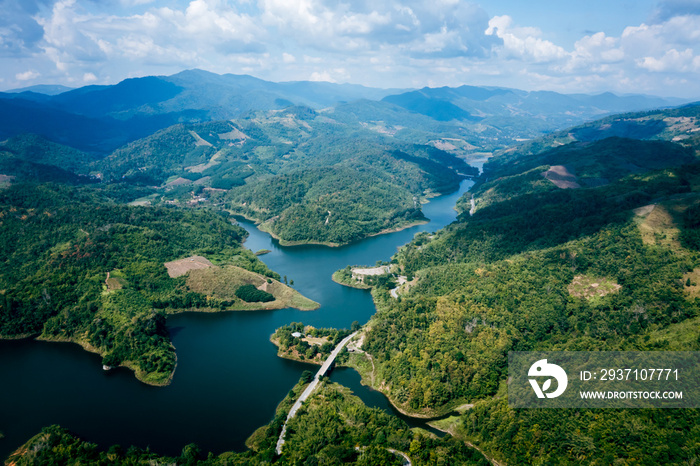 national reservoir or dam in the middle of the valley and the road connecting the city at chiang rai