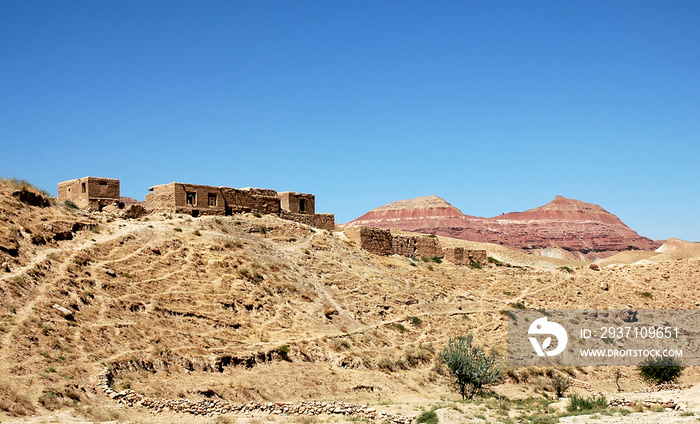 Village between Herat and Qala-e-Naw, Herat Province in Afghanistan with a backdrop of colorful red 