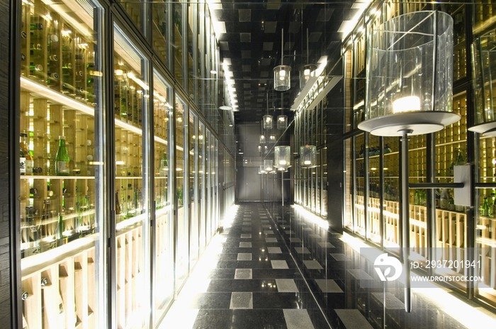 Passageway and lit lanterns in wine cellar