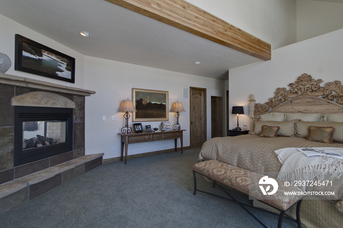 Bed end and fireplace in bedroom