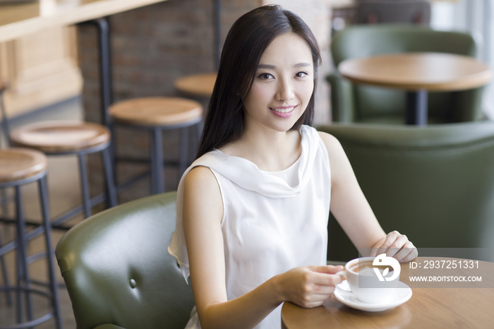 年轻女士在咖啡厅喝咖啡