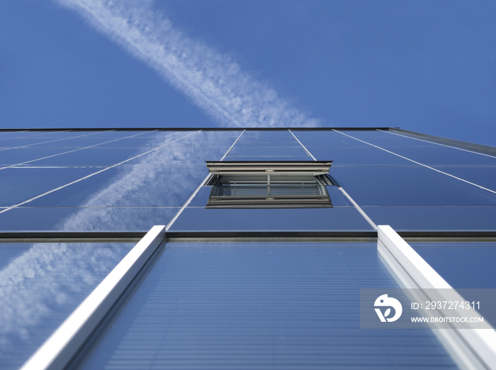 Low angle view of a vapor trail in a blue sky