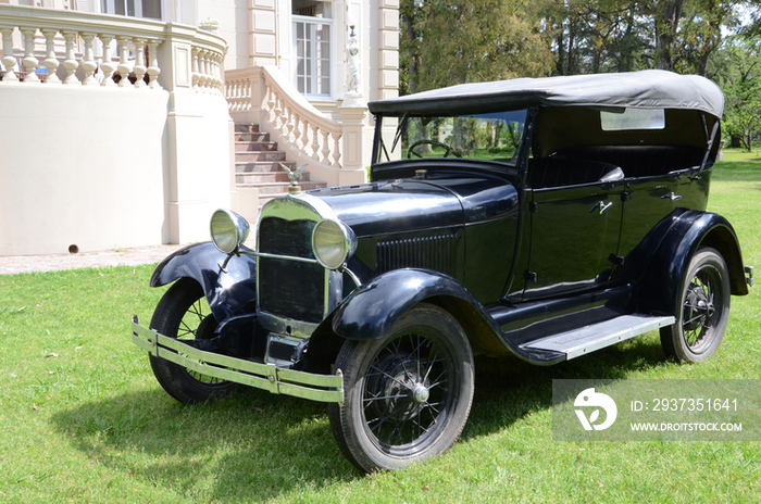 Black vintage car parked in yard