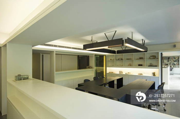 Fluorescent light hanging and modern conference table in office