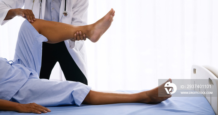 Physical therapist doing physical therapy for adult patient at hospital room.