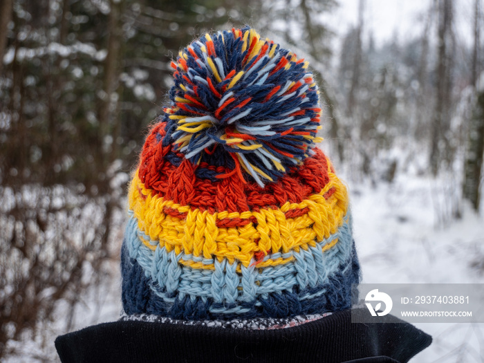 Image of woman wearing bobble hat close up