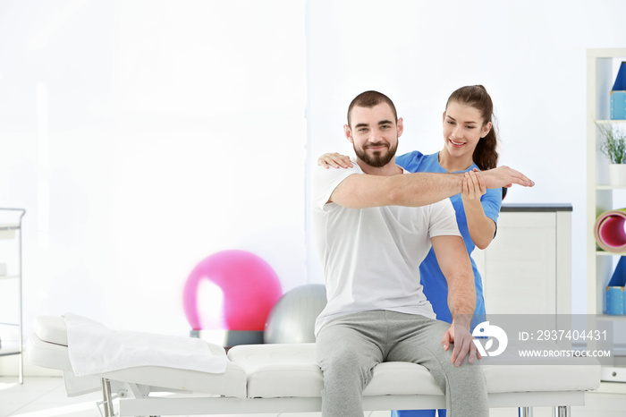 Physiotherapist working with patient in clinic